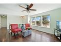 Cozy living room with hardwood floors and large windows providing ample natural light at 2781 Savage Rd, Elizabeth, CO 80107