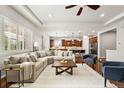 Bright open-concept living room boasts a cozy sectional, ceiling fan, and hardwood floors at 14134 Glenayre Cir, Parker, CO 80134