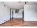 Open-concept living area boasts wood floors, a ceiling fan, and view to the kitchen at 3351 S Field St # 164, Lakewood, CO 80227