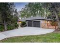 Large driveway leads to a well-maintained home, garage, and fenced private entrance at 2635 S Lamar Way, Lakewood, CO 80227