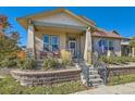 Inviting home with a cozy front porch, stone accents, and well-maintained landscaping at 149 Jewel St, Brighton, CO 80603
