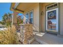 Charming front porch with a decorative wreath and comfortable seating at 149 Jewel St, Brighton, CO 80603