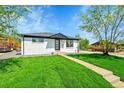 Charming single story home with a well-manicured lawn and inviting walkway at 7634 Navajo St, Denver, CO 80221