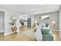 Bright living room with hardwood floors and an open layout leading to the kitchen at 7634 Navajo St, Denver, CO 80221