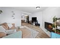 Bright living room features hardwood floors, fireplace, and modern furnishings, creating a cozy atmosphere at 311 W Lehow Ave # 3, Englewood, CO 80110