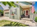 Inviting front porch with a patriotic display, brick accents, and seating area at 19771 E Wesley Pl, Aurora, CO 80013