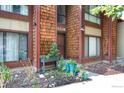 Attractive townhouse with potted plants adorning the entrance and lush, low-maintenance landscaping at 1255 S Dillon Way, Aurora, CO 80012