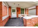 Inviting covered front porch with seating, perfect for relaxing outdoors at 2204 S Acoma St, Denver, CO 80223