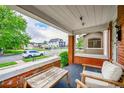 Welcoming front porch with a seating area and views of the quiet street at 2204 S Acoma St, Denver, CO 80223