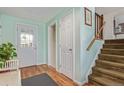 Inviting foyer with hardwood floors, neutral paint, and staircase to the upper level at 1313 Garden Cir, Longmont, CO 80501