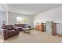 Bright living room featuring a large window and comfortable seating area at 1313 Garden Cir, Longmont, CO 80501