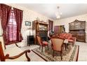 Cozy living room featuring floral wallpaper, vintage furniture and a fireplace at 200 Rose St, Georgetown, CO 80444