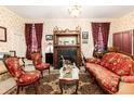 Inviting living room featuring a fireplace, vintage furniture, and warm lighting at 200 Rose St, Georgetown, CO 80444