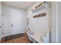 Inviting entryway featuring a storage bench, coat hooks and decor at 42363 Glen Abbey Dr, Elizabeth, CO 80107