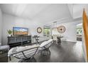 Open-concept dining room with dark wood floors, modern lighting, and stylish decor at 17395 E Dewberry Dr, Parker, CO 80134