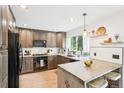 Well-lit kitchen featuring modern appliances, plenty of counter space, and large windows at 6678 S Arapahoe Dr, Littleton, CO 80120