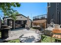 Spacious backyard with a modern garage, hammock, stylish seating, and patio area at 3618 Navajo St, Denver, CO 80211