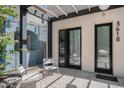 Welcoming front porch with stylish seating and modern black framed doors at 3618 Navajo St, Denver, CO 80211