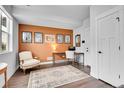 Stylish home office with accent wall, hardwood floors, and modern furniture at 3458 W 63Rd Ave, Denver, CO 80221