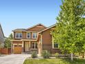Charming two-story home featuring a three-car garage, brick accents, and a well-manicured front yard at 10045 Copenhagen St, Parker, CO 80134