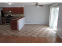 Open kitchen and dining area with tile floors and sliding glass door to outdoor at 19025 E Bethany Pl, Aurora, CO 80013
