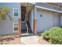Apartment building entrance with private stairwell and mature landscaping at 3141 S Tamarac Dr # 206E, Denver, CO 80231