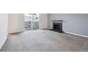 Bright living room with a fireplace and sliding glass doors leading to the outside at 3141 S Tamarac Dr # 206E, Denver, CO 80231