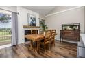 Dining room features a rustic wood table and a decorative fireplace with a large cow print at 6513 Pinewood Dr, Parker, CO 80134
