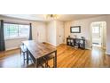 Inviting living room with hardwood floors, a large window, and a modern light fixture at 3241 Sheridan Blvd, Wheat Ridge, CO 80212