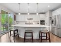 Bright and modern kitchen with white cabinets, stainless steel appliances, and a large center island at 1920 Pioneer Cir, Lafayette, CO 80026