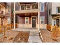 Inviting two-story home with a covered porch, featuring a modern entrance and well-kept landscaping at 15018 Cast Pebble Cir, Parker, CO 80134