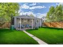 Spacious backyard with covered patio and lush green grass at 1164 Chester St, Aurora, CO 80010