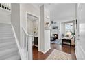 Bright entryway with staircase, powder room, and view of living room at 14653 E Crestridge Dr, Centennial, CO 80015