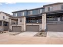 Modern townhomes with spacious garages and inviting balconies offering a blend of comfort and style at 16744 W 93Rd Pl, Arvada, CO 80007