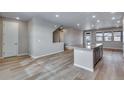 Open-concept kitchen featuring a center island with stone countertops, stainless steel appliances, and abundant natural light at 16744 W 93Rd Pl, Arvada, CO 80007