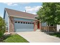 A single Gathering home featuring a gray door and a large manicured lawn at 13959 E 106Th Ave, Commerce City, CO 80022