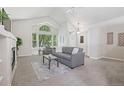 Bright living room with vaulted ceilings, fireplace, and large windows offering natural light at 13959 E 106Th Ave, Commerce City, CO 80022