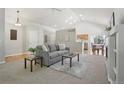 Inviting living room with vaulted ceiling, neutral color scheme, and smooth carpet at 13959 E 106Th Ave, Commerce City, CO 80022