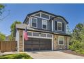 Charming two-story home boasts a two-car garage, stone accents, and a well-maintained lawn at 9545 Grand Cypress Cv, Lone Tree, CO 80124
