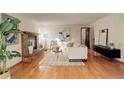 Living room with hardwood floors, a brick fireplace and neutral decor at 722 S Eagle St, Aurora, CO 80012