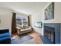 Bright living room with fireplace, hardwood floors, love seat, and natural light at 12125 Bannock St # C, Westminster, CO 80234