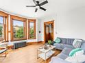 Bright living room with hardwood floors, large windows, and cozy seating at 2124 E 17Th Ave # 4, Denver, CO 80206