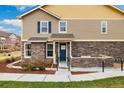 Charming two-story home featuring a mix of stone and siding with a covered front patio area at 12744 Leyden St # F, Thornton, CO 80602