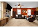 Inviting living room with plush leather seating, a fireplace, and large windows for natural light at 12744 Leyden St # F, Thornton, CO 80602