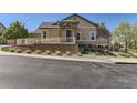 Charming home featuring a stone-accented entryway, well-maintained landscaping, and a welcoming facade on a sunny day at 6655 S Shawnee St, Aurora, CO 80016
