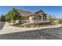 Beautiful home showcases manicured landscaping, stylish stone accents, a covered porch, and a two car garage at 6655 S Shawnee St, Aurora, CO 80016