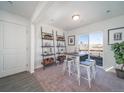 Bright dining area includes a table with seating for four and access to decor shelving and a view of the neighborhood at 13588 E 103Rd Pl, Commerce City, CO 80022