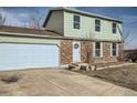 Front view of a two-story house with a white garage door and brick accents at 11058 Grange Creek Dr, Thornton, CO 80233