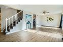 Bright living room with hardwood floors, ceiling fan, and view to kitchen at 11058 Grange Creek Dr, Thornton, CO 80233