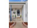Cozy front porch with stylish number post, plants, and 'Welcome' mat at 6751 Locust St, Commerce City, CO 80022